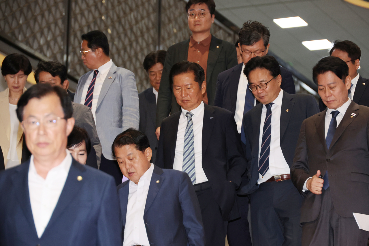 Democratic Party lawmakers are seen walking out of the main hall of the National Assembly during the plenary session on Monday, as the People Power Party launched a filibuster against a Democratic Party-led bill to change governance structure of a public broadcasting company KBS. (Yonhap)
